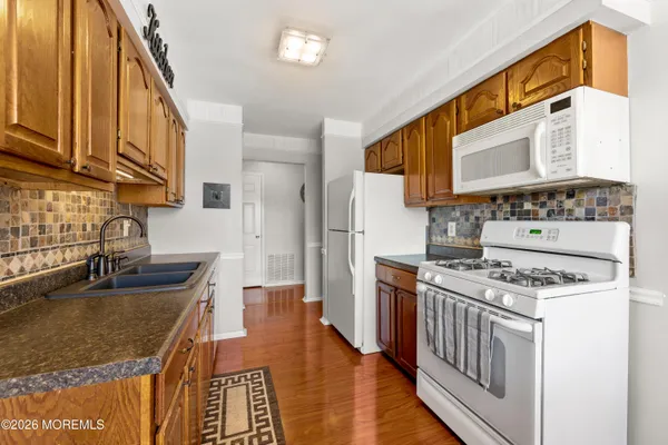 a kitchen with stainless steel appliances granite countertop a stove and a sink