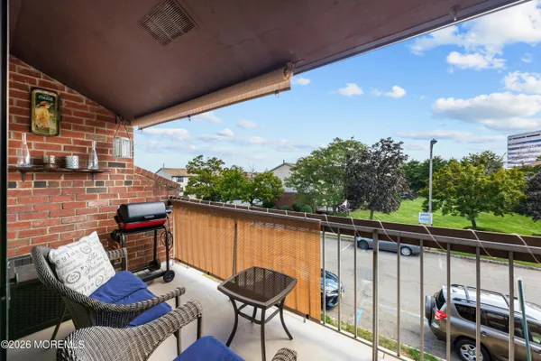 a balcony with table and chairs