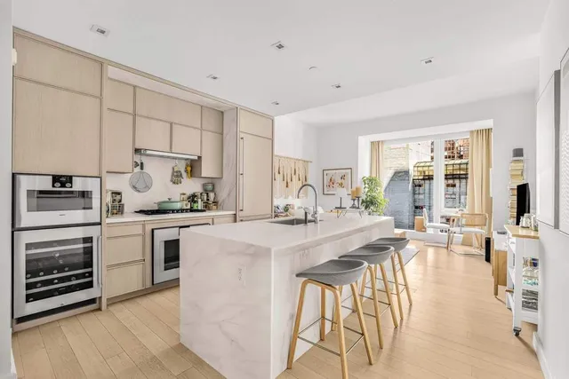 a kitchen with appliances a sink and cabinets