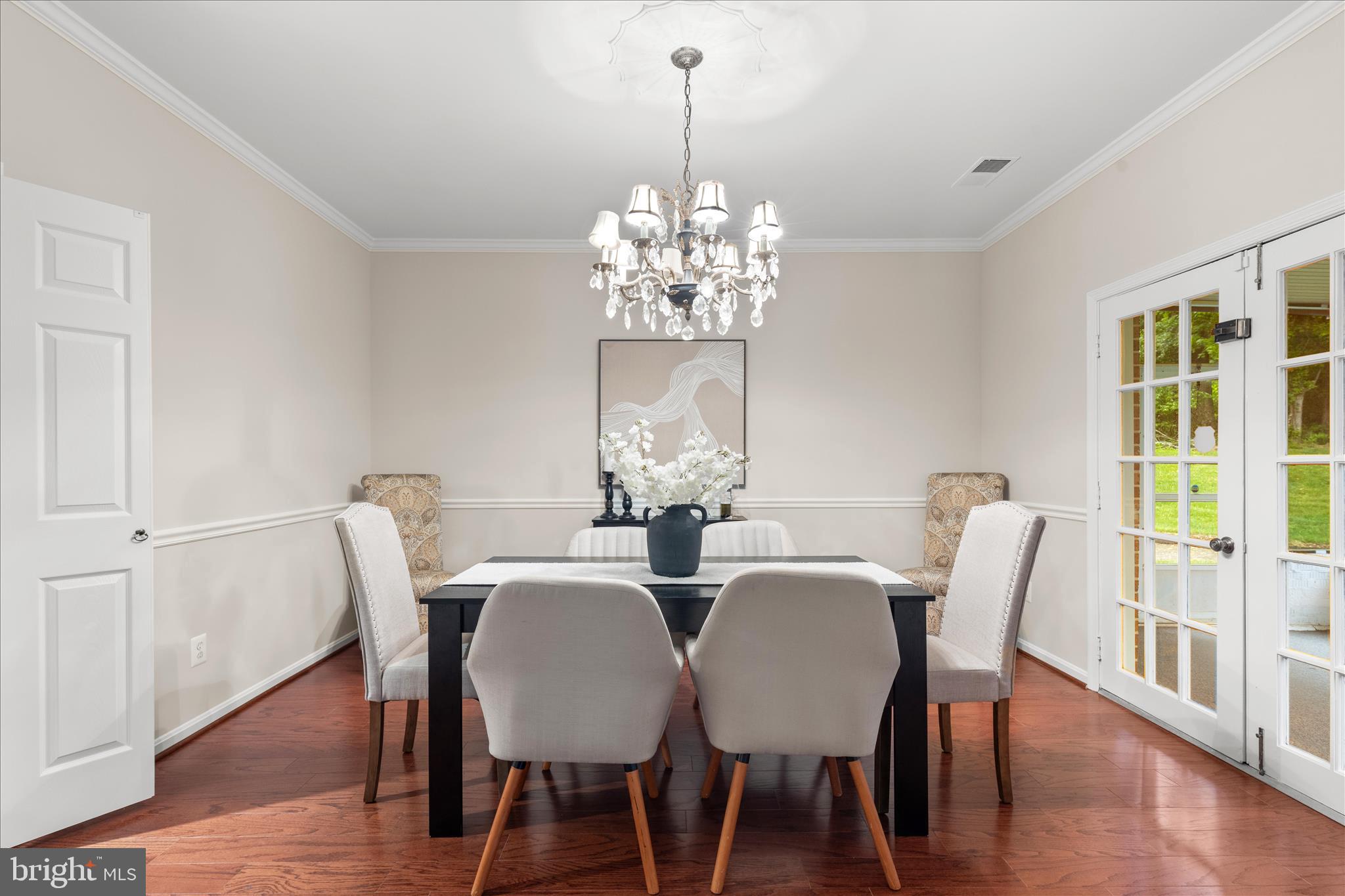 10205 Old Hunt Road Vienna, VA 22181 - Photo 23 of 67 a view of a dining room with furniture a chandelier and wooden floor