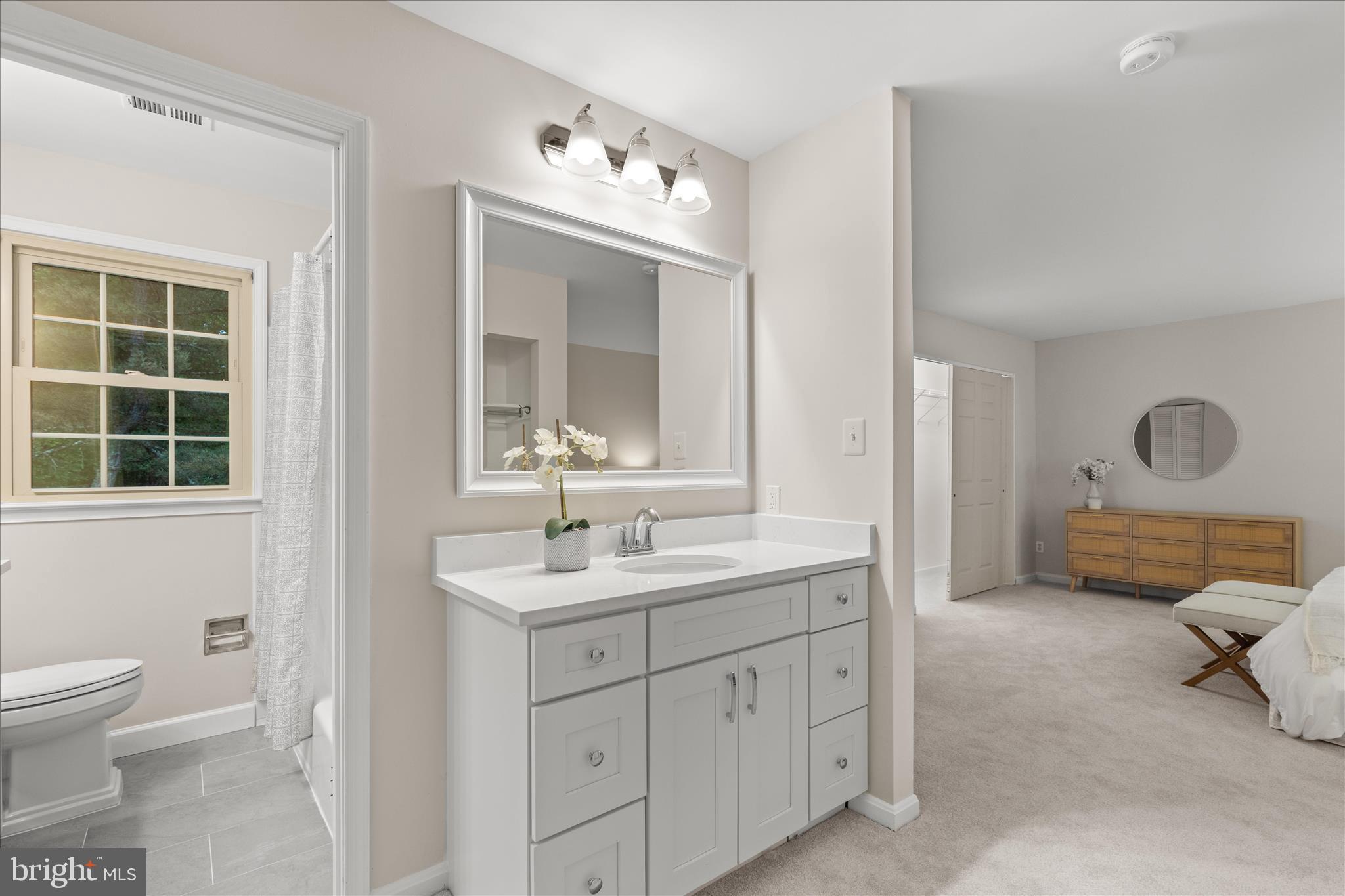 10205 Old Hunt Road Vienna, VA 22181 - Photo 47 of 67 a spacious bathroom with a double vanity sink a mirror and a toilet