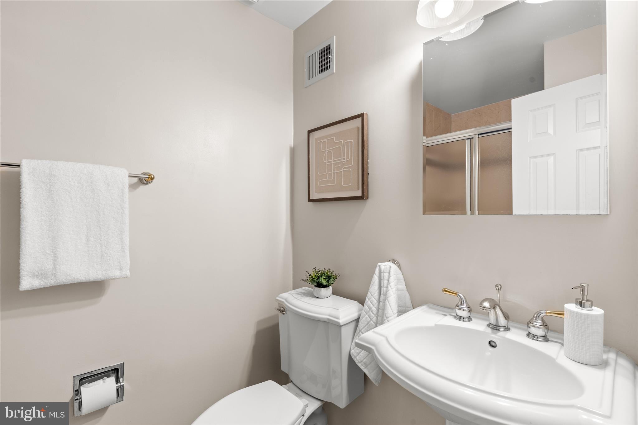 10205 Old Hunt Road Vienna, VA 22181 - Photo 54 of 67 a bathroom with a sink mirror and toilet