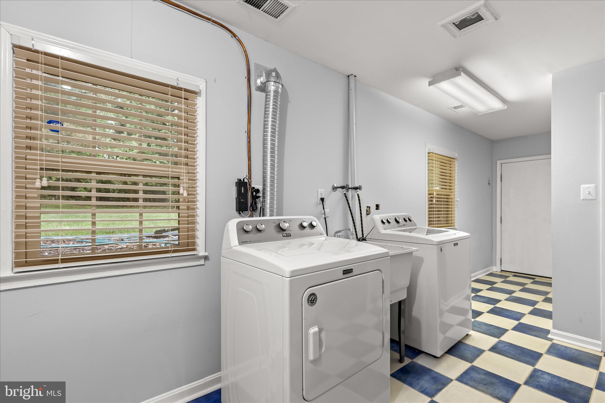 10205 Old Hunt Road Vienna, VA 22181 - Photo 56 of 67 a kitchen with a sink a stove and a window
