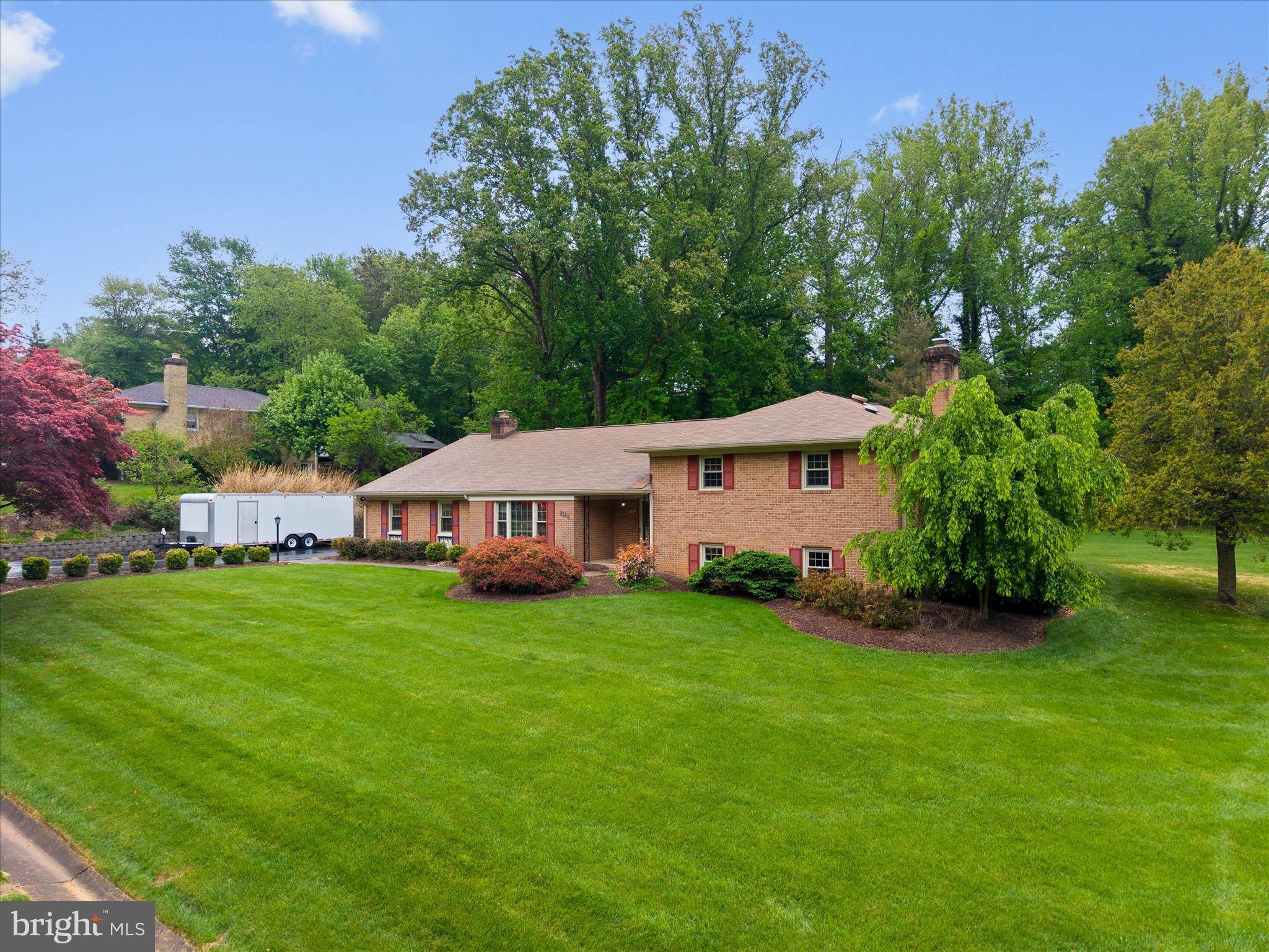 10205 Old Hunt Road Vienna, VA 22181 - Photo 63 of 67 a aerial view of a house next to a big yard and large trees