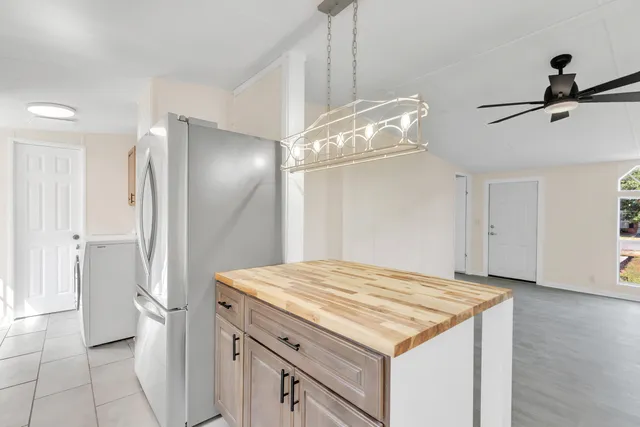 a kitchen with a refrigerator and countertop
