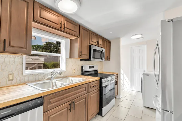 a kitchen with a sink stove and microwave