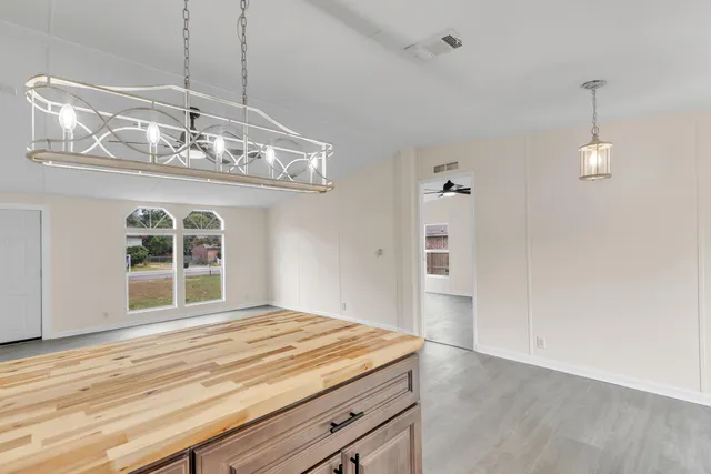 an empty room with a empty space and a ceiling fan