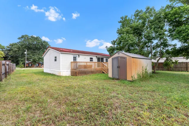 a view of a backyard with large trees