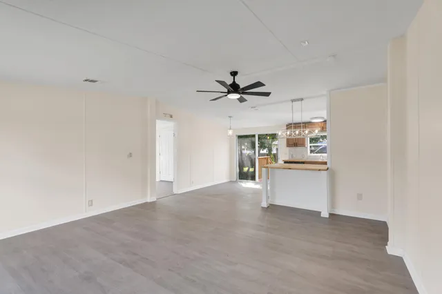 a view of a kitchen with a sink and a refrigerator