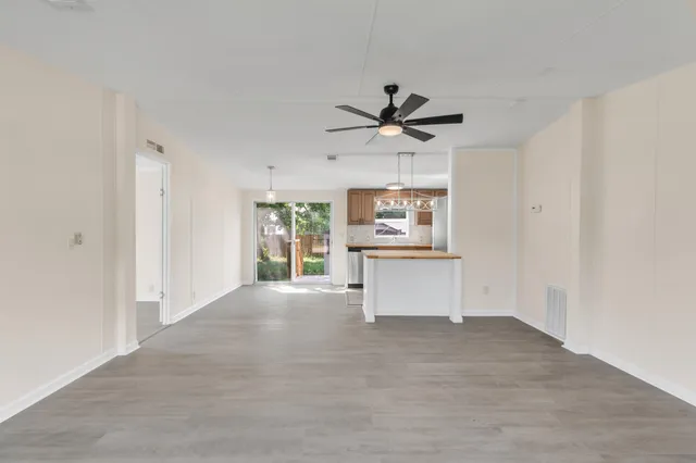 a view of a big room with windows and cabinet