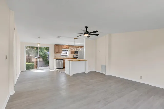 a view of a kitchen with a sink and a window