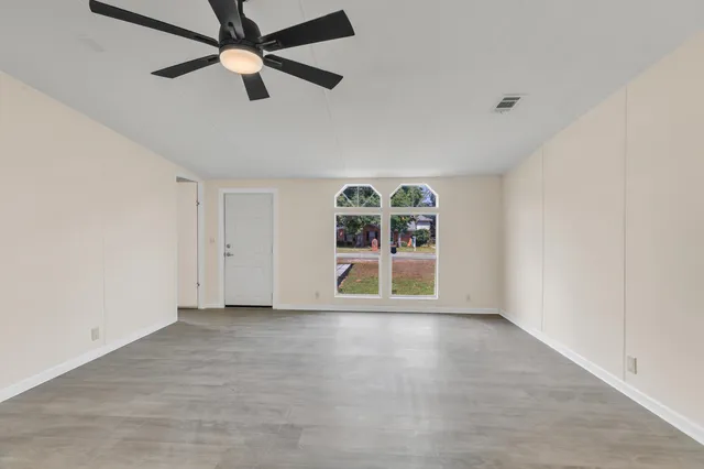 wooden floor in an empty room with a window