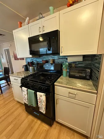 a kitchen with a stove and a microwave