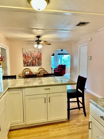 a view of a dining room with furniture and a chandelier