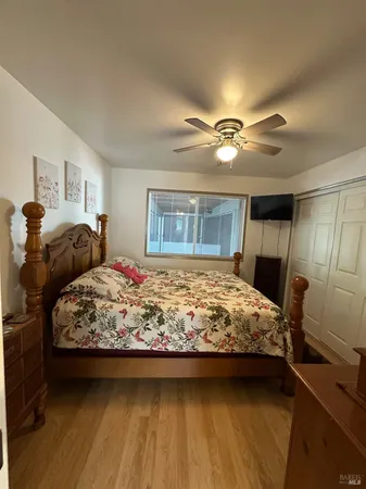 a bathroom with a granite countertop toilet sink and mirror