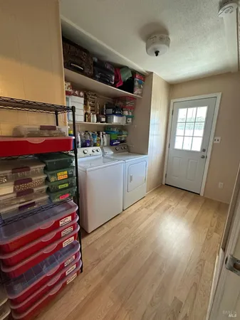 a view of washer and dryer with wooden floor