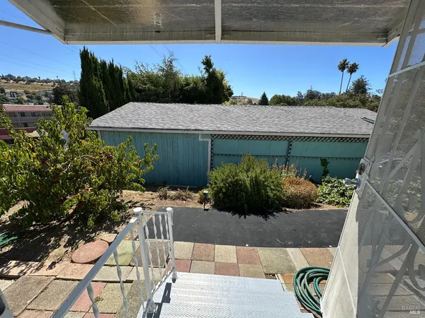 a view of a backyard with potted plants