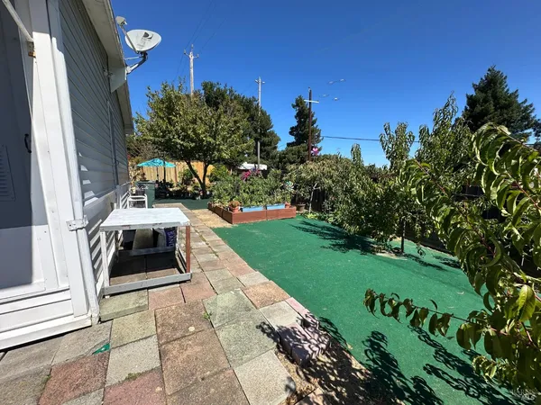 a view of a backyard with sitting area