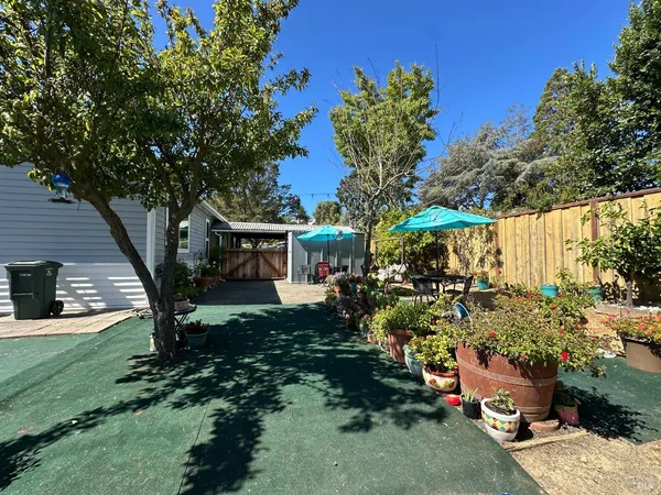 a view of a backyard with sitting area and furniture