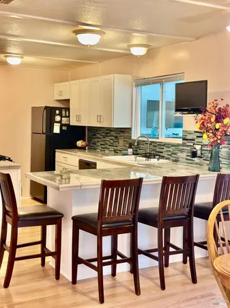 a kitchen with a table chairs and a refrigerator