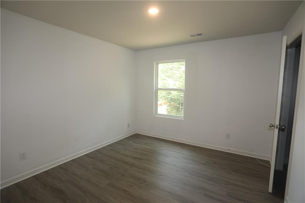 25 Lena Court Covington, GA 30016 - Photo 11 of 36 an empty room with wooden floor and windows