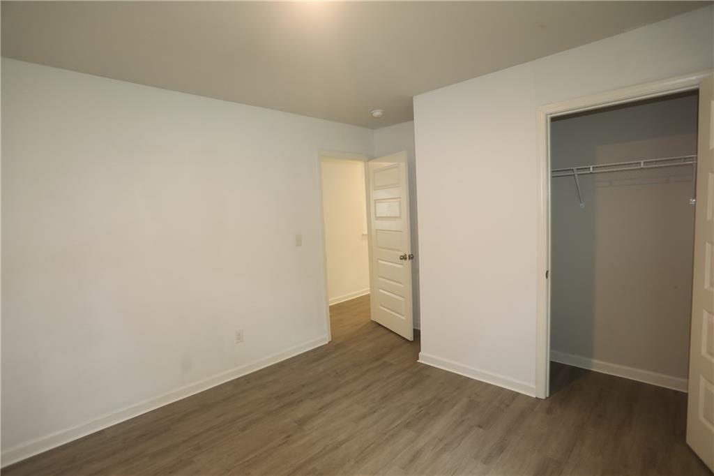 25 Lena Court Covington, GA 30016 - Photo 15 of 36 a view of an empty room with wooden floor and closet
