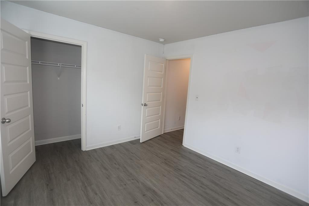 25 Lena Court Covington, GA 30016 - Photo 20 of 36 an empty room with wooden floor and closet