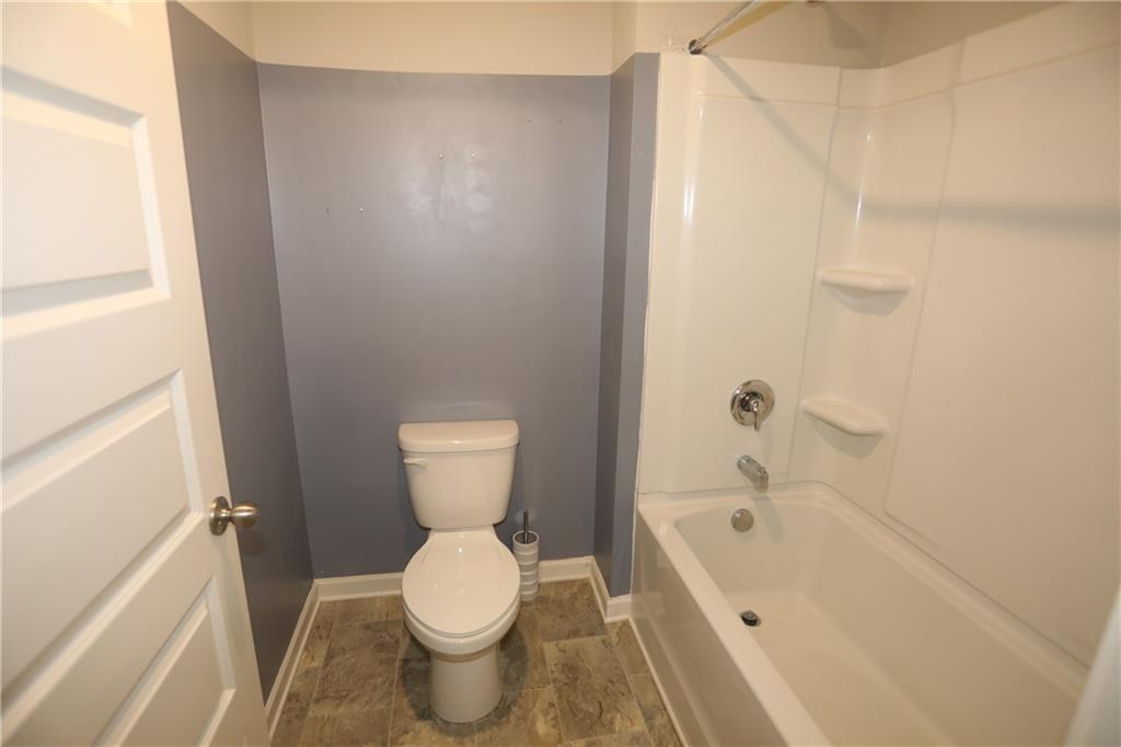 25 Lena Court Covington, GA 30016 - Photo 21 of 36 a bathroom with a toilet and a bathtub