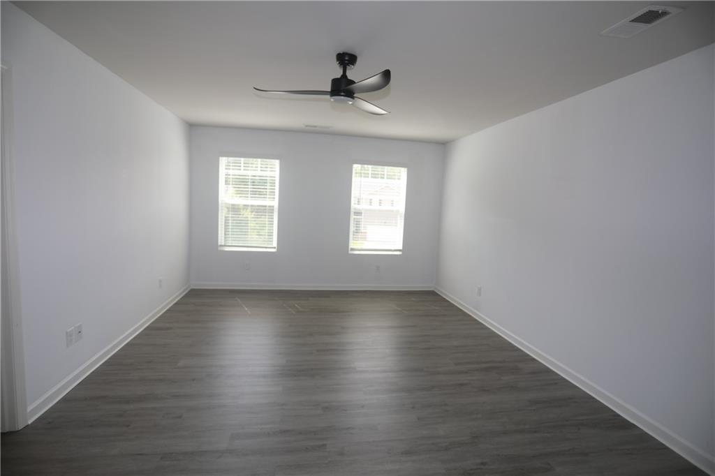 25 Lena Court Covington, GA 30016 - Photo 22 of 36 an empty room with wooden floor and windows