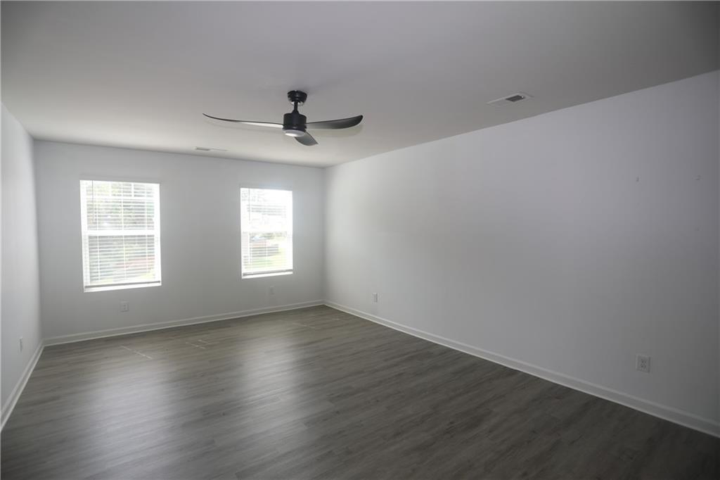25 Lena Court Covington, GA 30016 - Photo 23 of 36 an empty room with wooden floor and windows