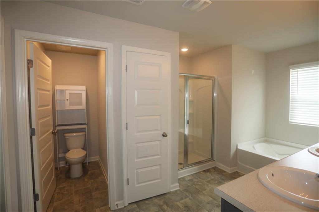 25 Lena Court Covington, GA 30016 - Photo 25 of 36 a bathroom with a sink a toilet and shower