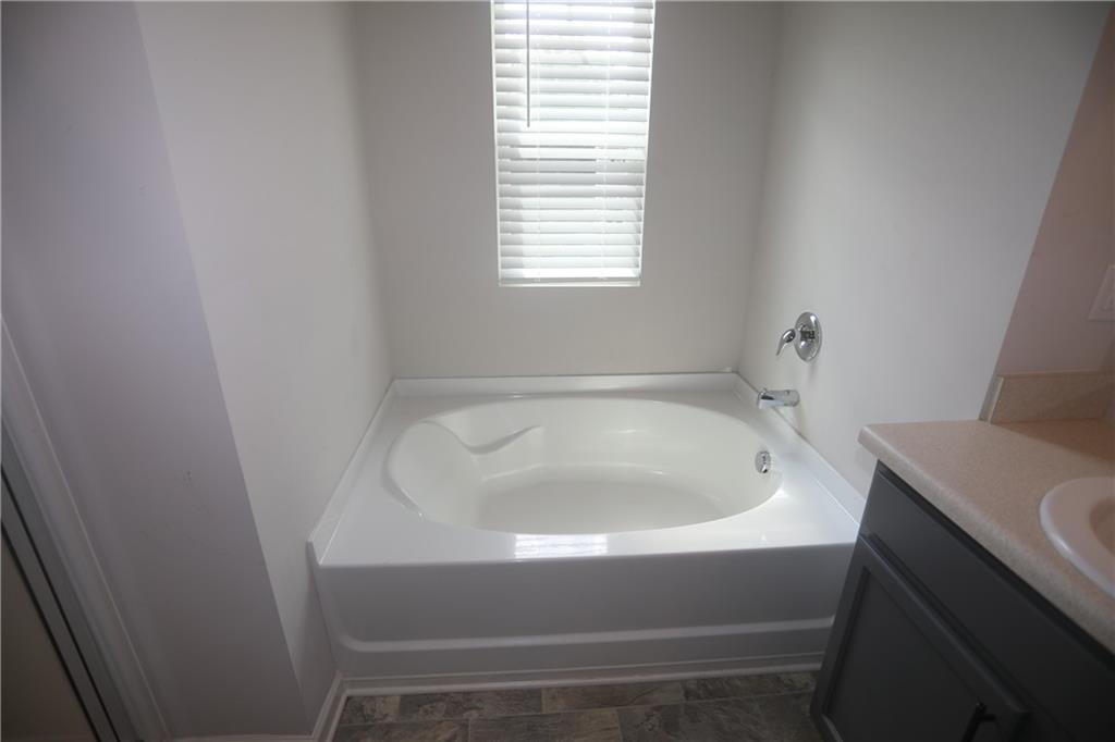 25 Lena Court Covington, GA 30016 - Photo 29 of 36 a bathroom with a sink and a bathtub