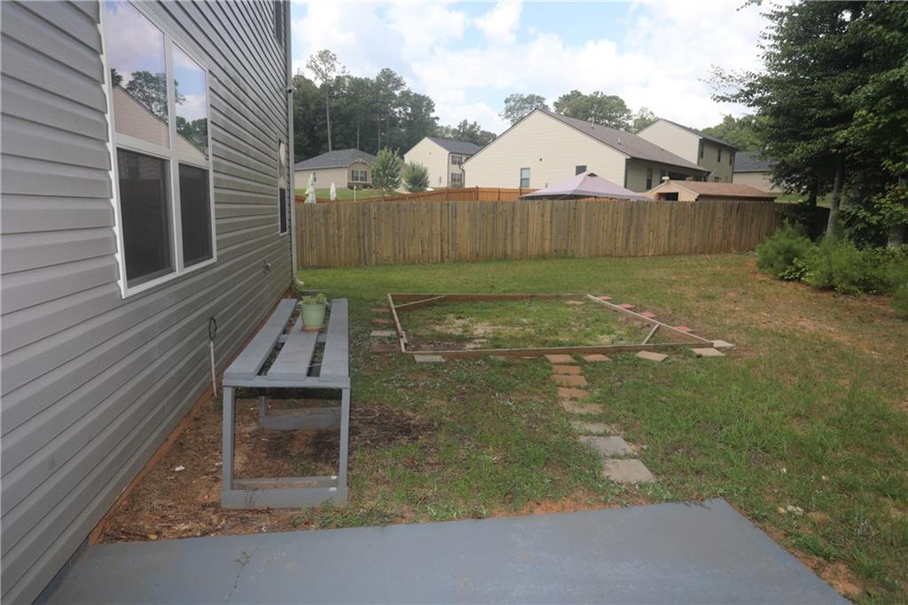 25 Lena Court Covington, GA 30016 - Photo 33 of 36 a view of a backyard with a garden and stairs