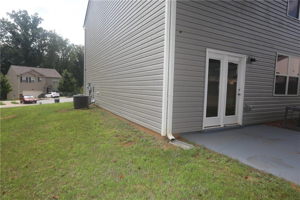 25 Lena Court Covington, GA 30016 - Photo 35 of 36 a view of a house with a yard and garage