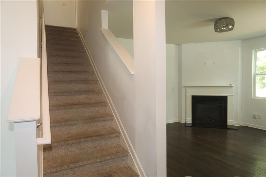 25 Lena Court Covington, GA 30016 - Photo 6 of 36 a view of a hallway with wooden floor and staircase