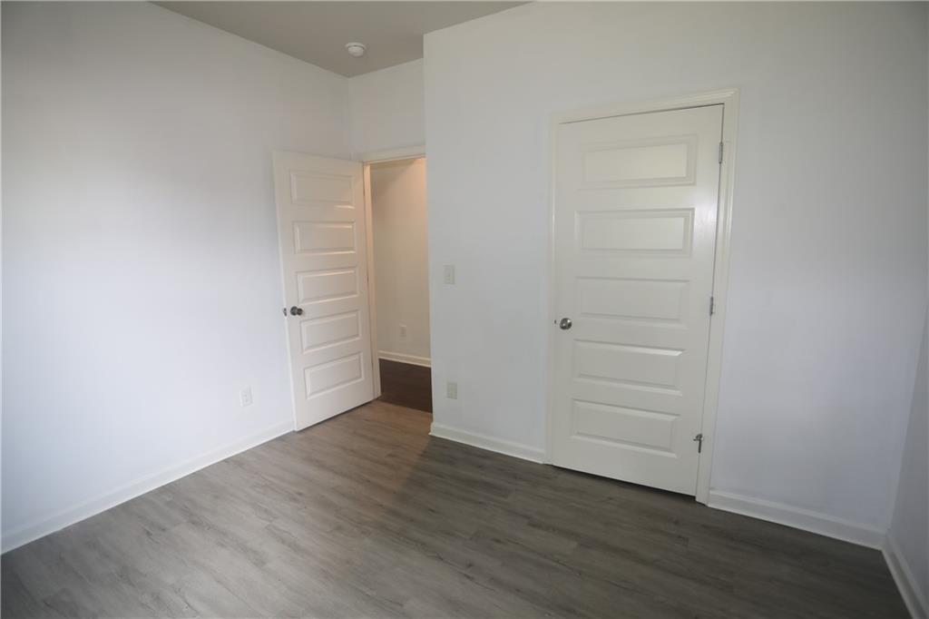 25 Lena Court Covington, GA 30016 - Photo 7 of 36 an empty room with wooden floor