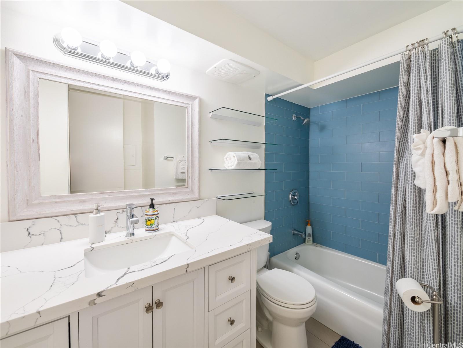 2572 Lemon Road, Unit 610 Honolulu, HI 96815 - Photo 17 of 24 a bathroom with a sink a toilet and shower