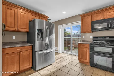a kitchen with stainless steel appliances granite countertop a refrigerator stove and sink