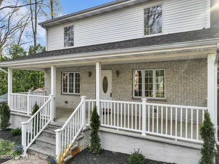 a view of a house with a small deck