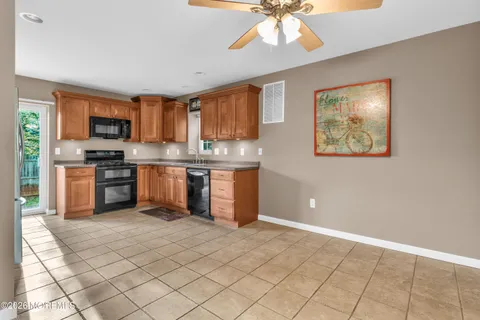 a kitchen with stainless steel appliances granite countertop a stove top oven a sink a counter top space and cabinets