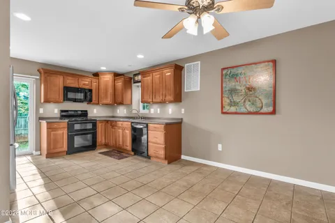 a kitchen with stainless steel appliances granite countertop a stove a sink and a refrigerator
