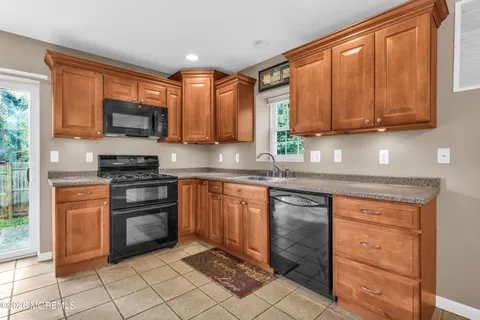 a kitchen with stainless steel appliances granite countertop a stove microwave and sink