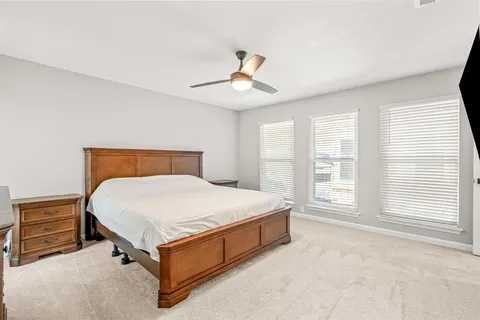 a bed sitting in a bedroom next to a window