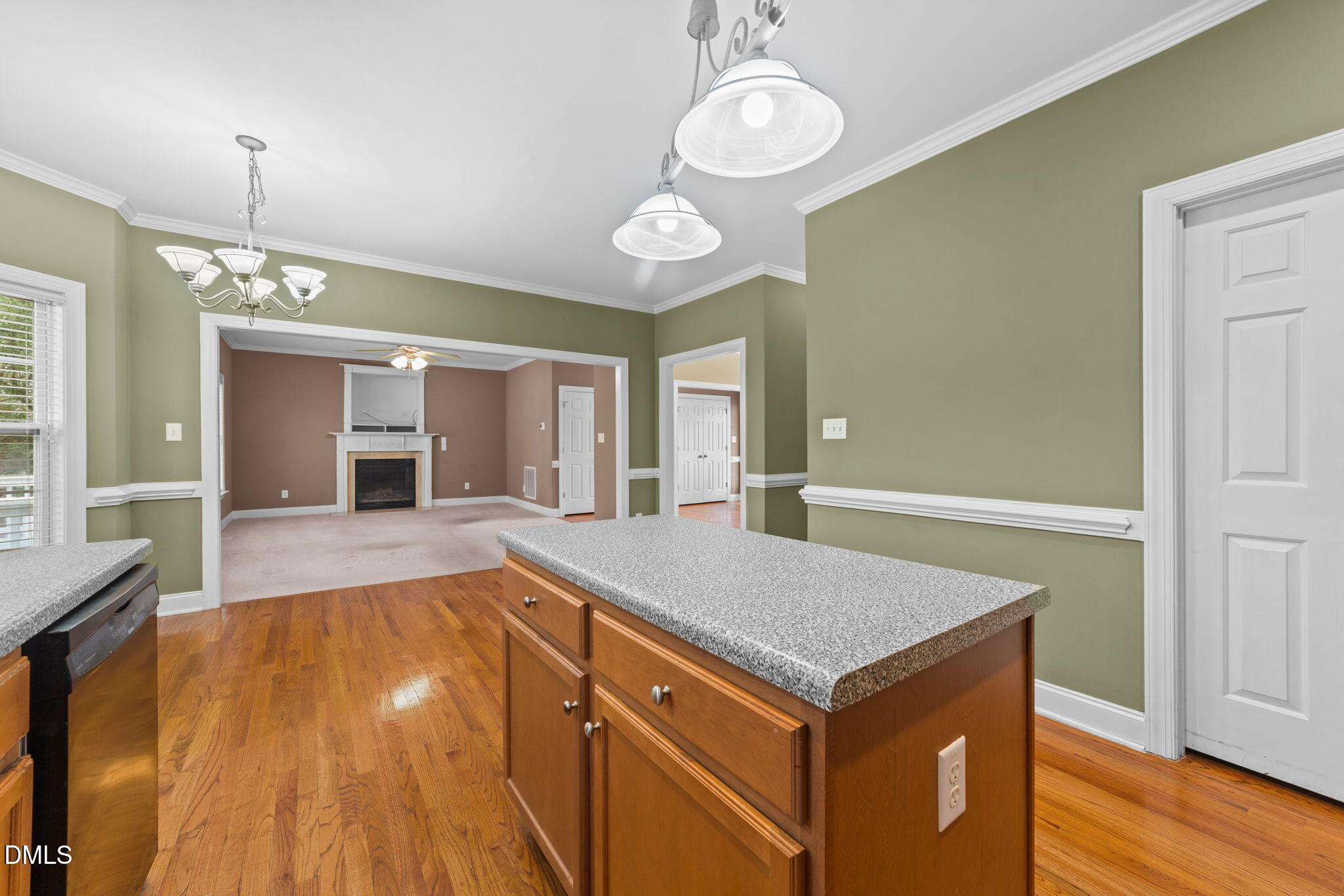 83 Larson Court Clayton, NC 27520 - Photo 11 of 35 a view of an empty room and kitchen with wooden floor
