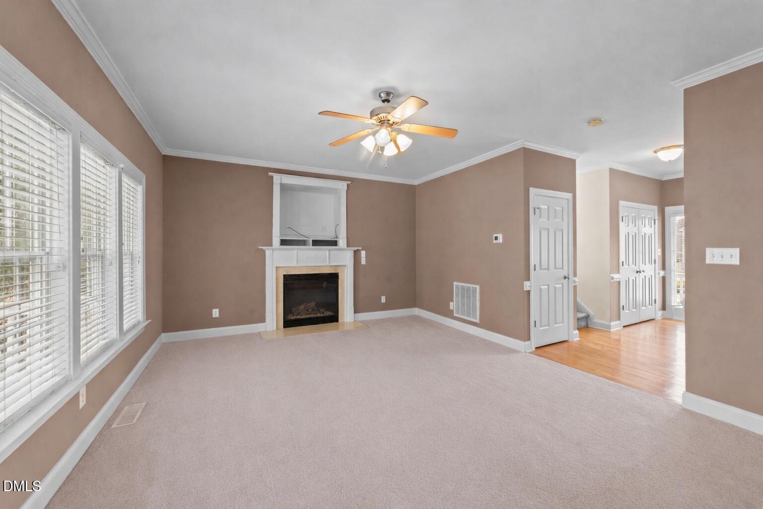83 Larson Court Clayton, NC 27520 - Photo 14 of 35 a view of an empty room with a fireplace and a window