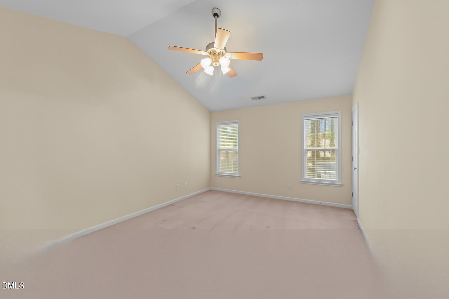 83 Larson Court Clayton, NC 27520 - Photo 21 of 35 an empty room with windows and chandelier fan
