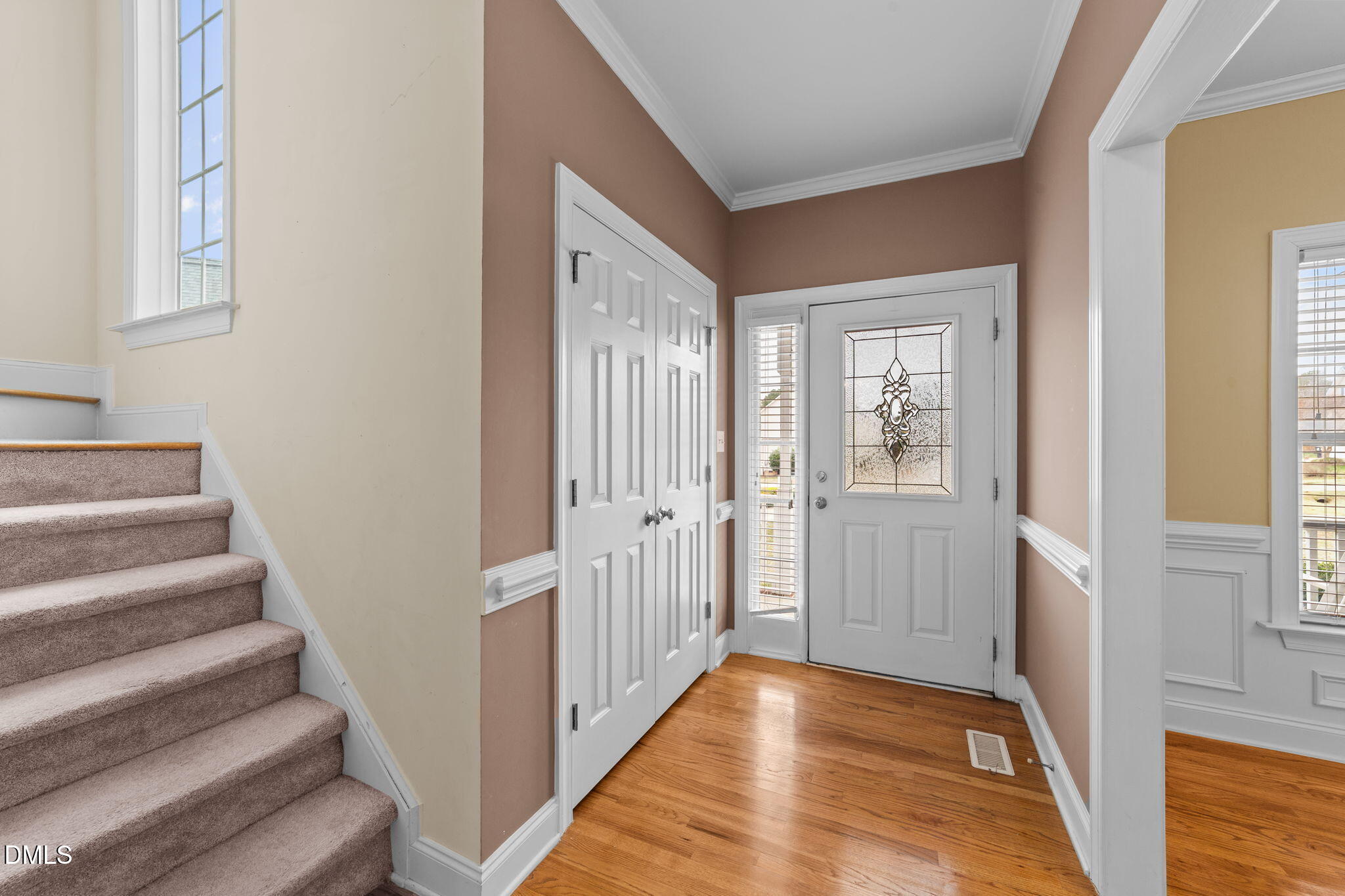 83 Larson Court Clayton, NC 27520 - Photo 5 of 35 a view of a hallway with wooden floor and staircase