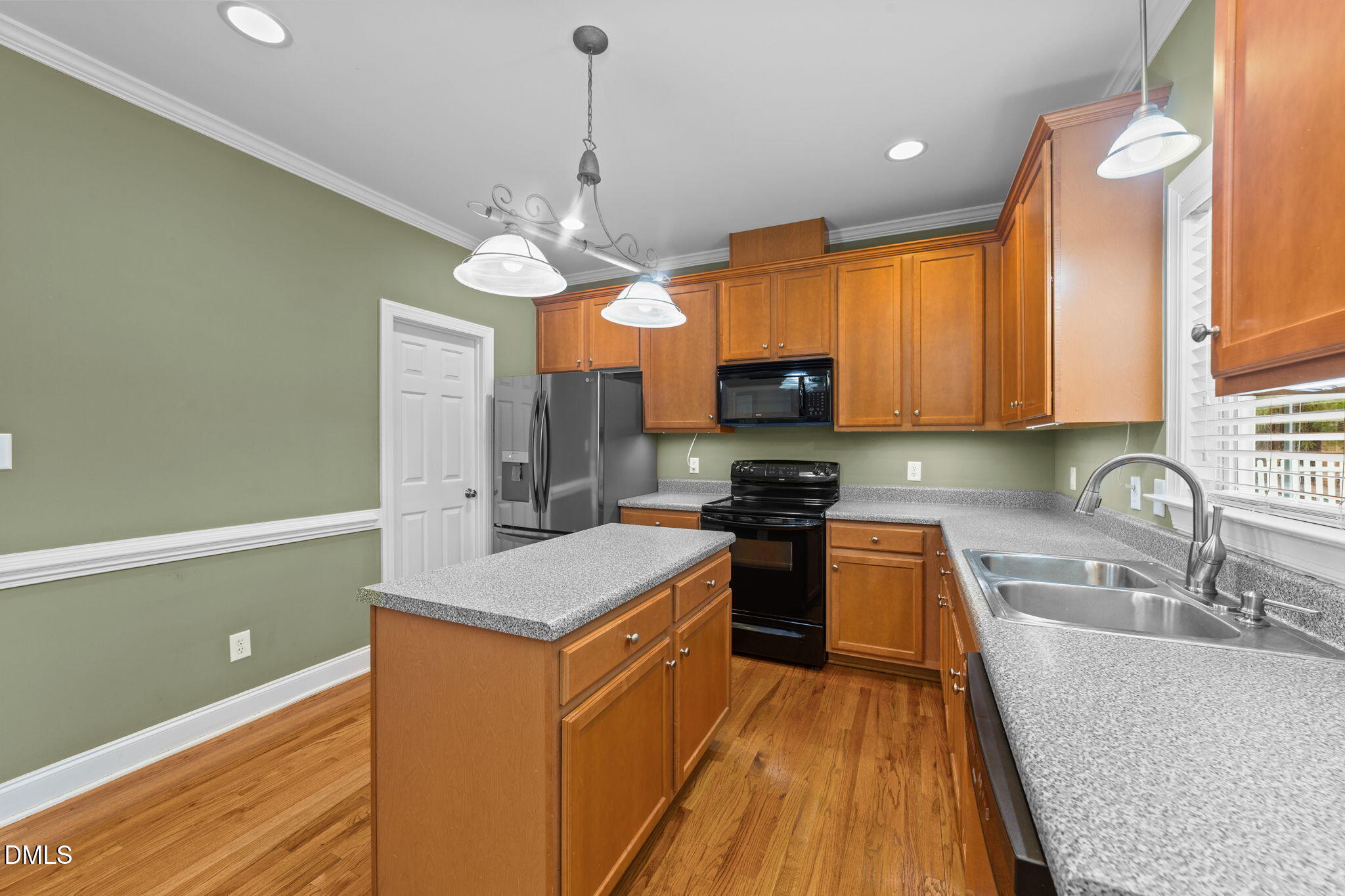 83 Larson Court Clayton, NC 27520 - Photo 9 of 35 a kitchen with stainless steel appliances granite countertop a sink a stove top oven a counter space and cabinets