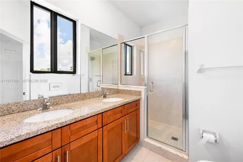 a bathroom with a granite countertop sink mirror and double