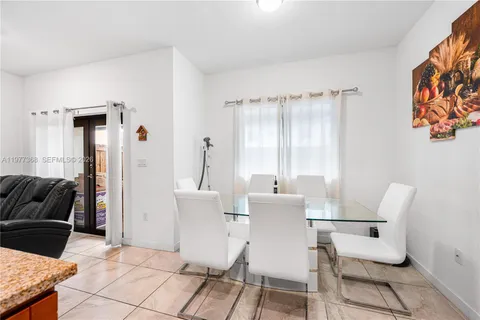 a view of a dining room with furniture and a rug